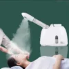 Sc8531b35c21c4cf3a830f8cd6f7aaed6p-1.webp Ozone Facial Steamer — Warm Mist Deep-Cleaning Spa Vaporizer